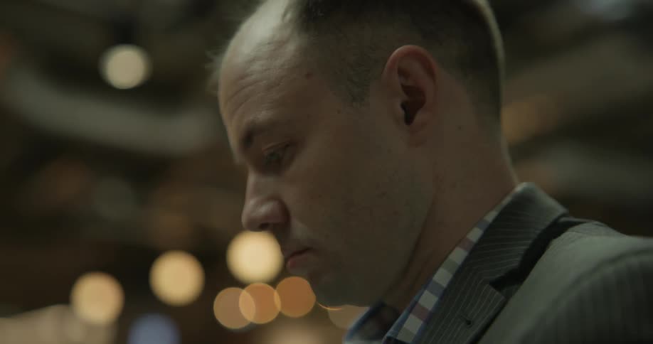 A man looks at something out of the frame