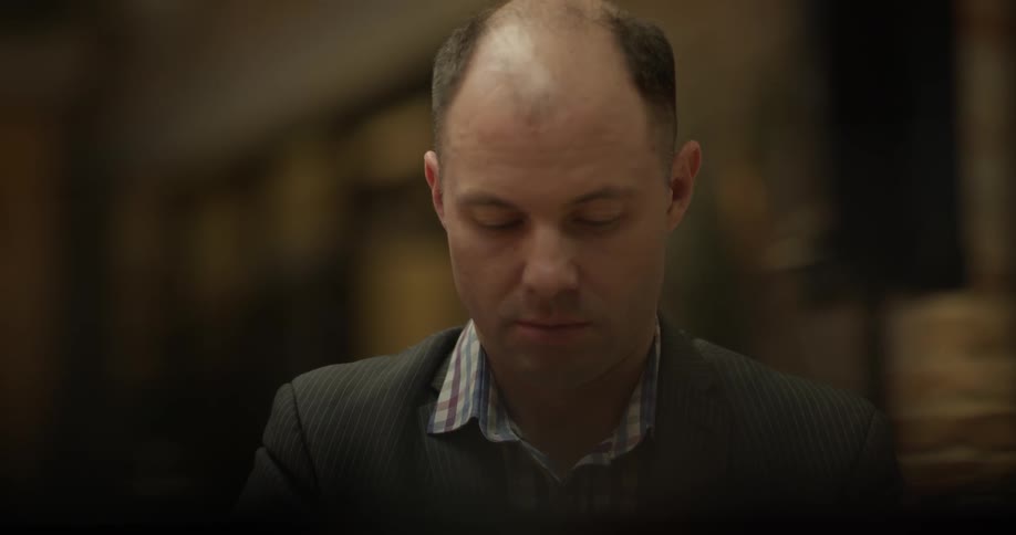 Bald hair man play the piano indoors at night