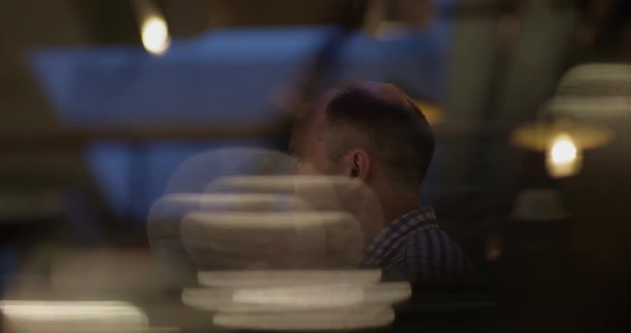 A man sits in a dark room talking