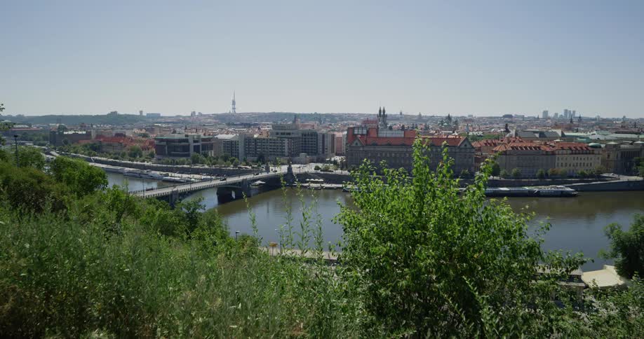 A old city viewed by a river crossed by a bridge