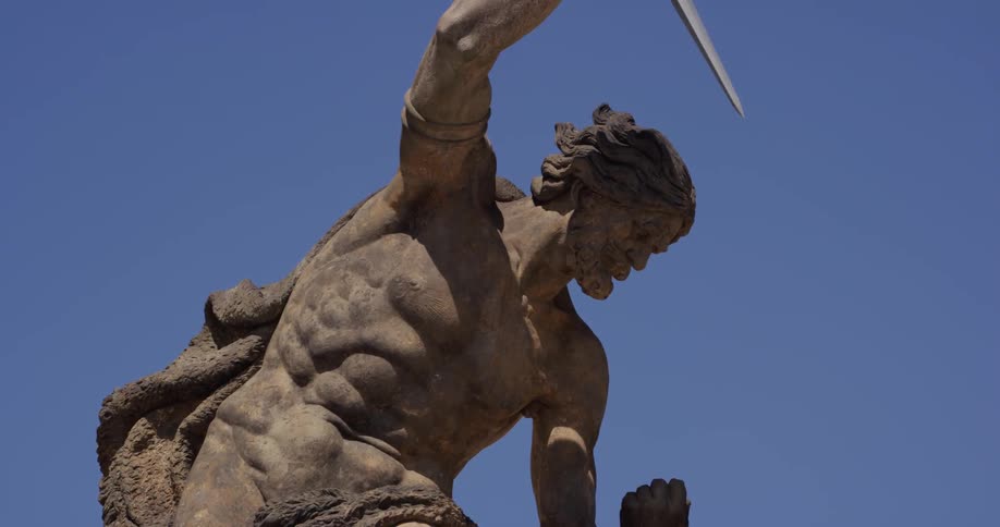 Statue of bare chested man holding a sword