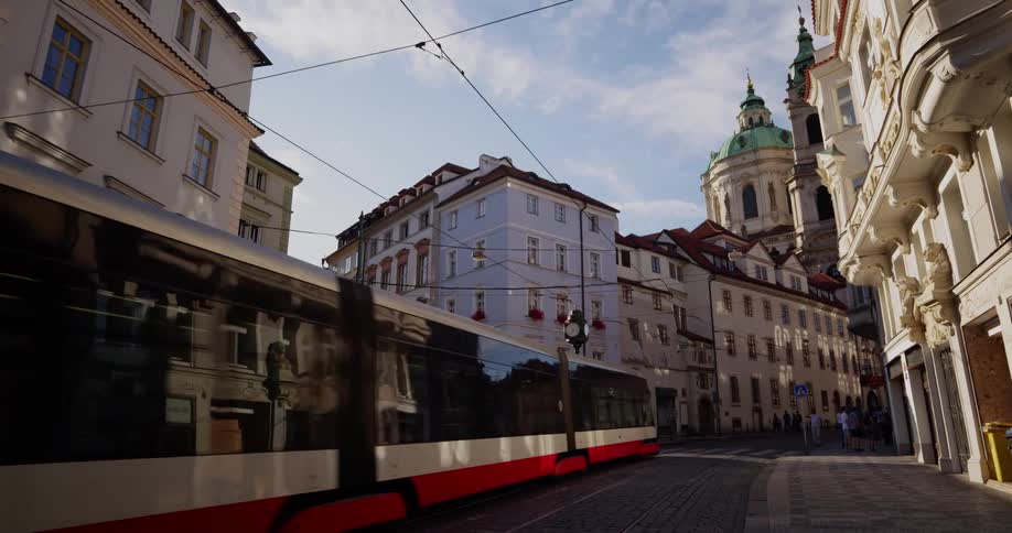 A large trolley goes through a city intersection