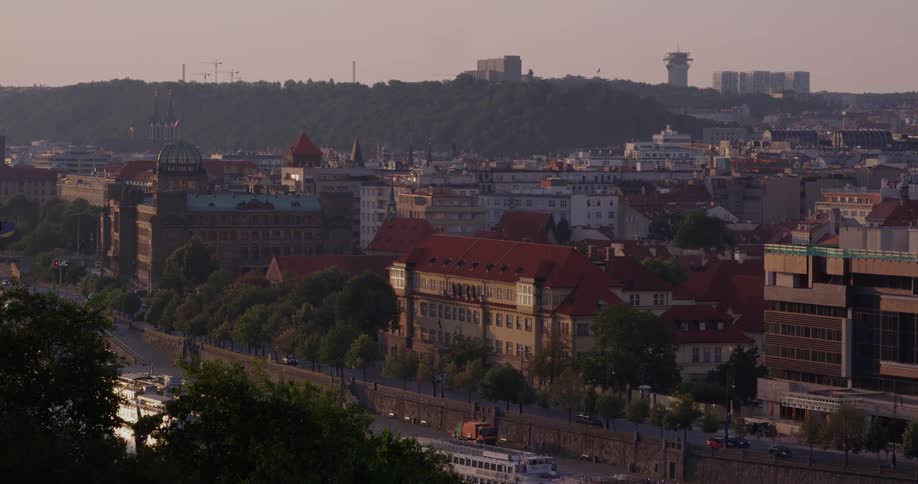 Skyline of the city with vehicles driving on the road