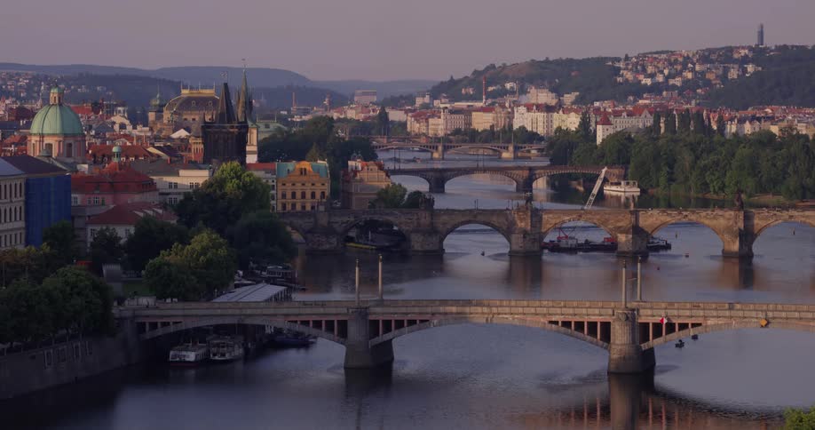 A series of bridges spanning a river during the evening