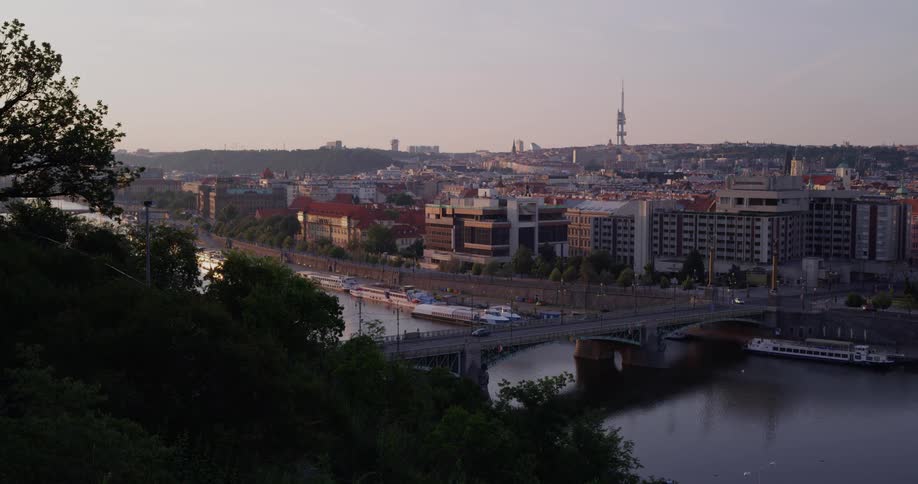 A bridge over a river with the city in the background