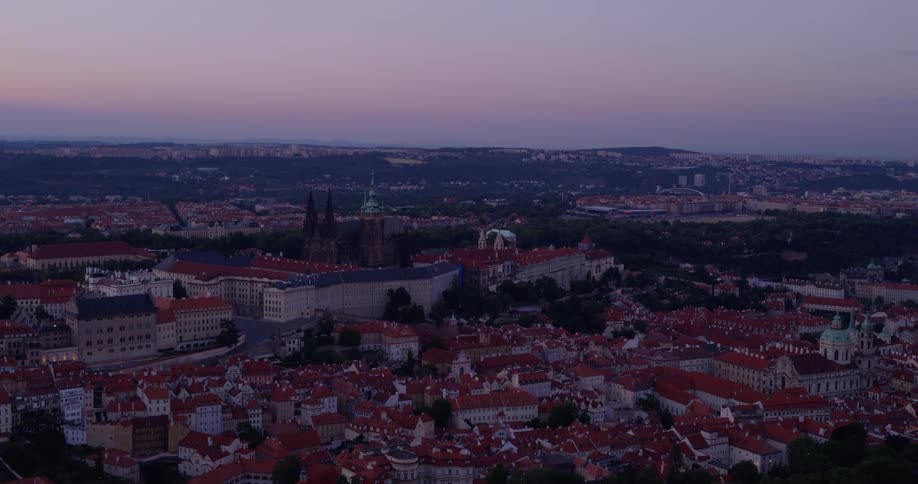 A sprawling european city with a lot of older architecture surrounds a large central building that appears to be a sizable palace or government building