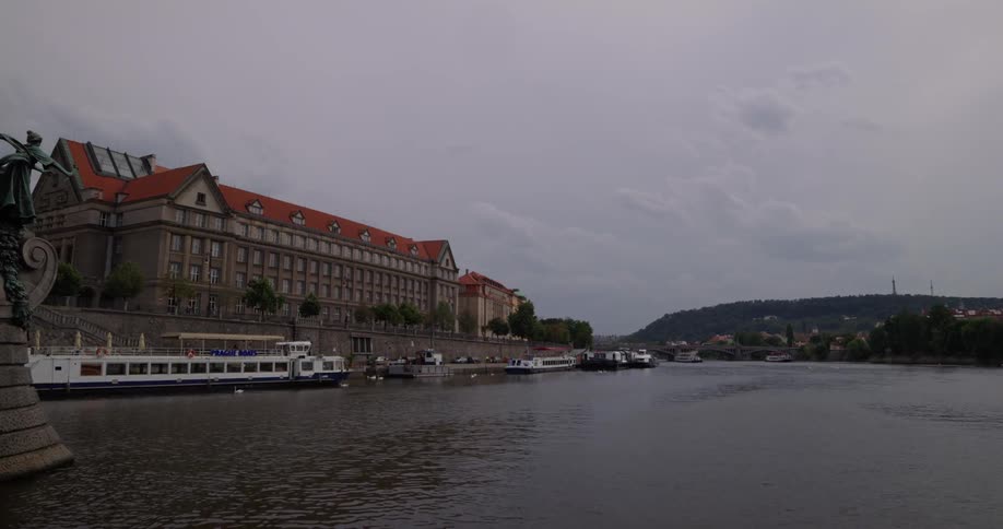 Underneath a bridge on a river with boats