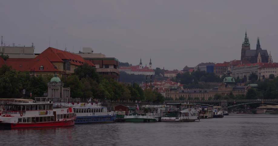 Multiple boats line the coast of a city