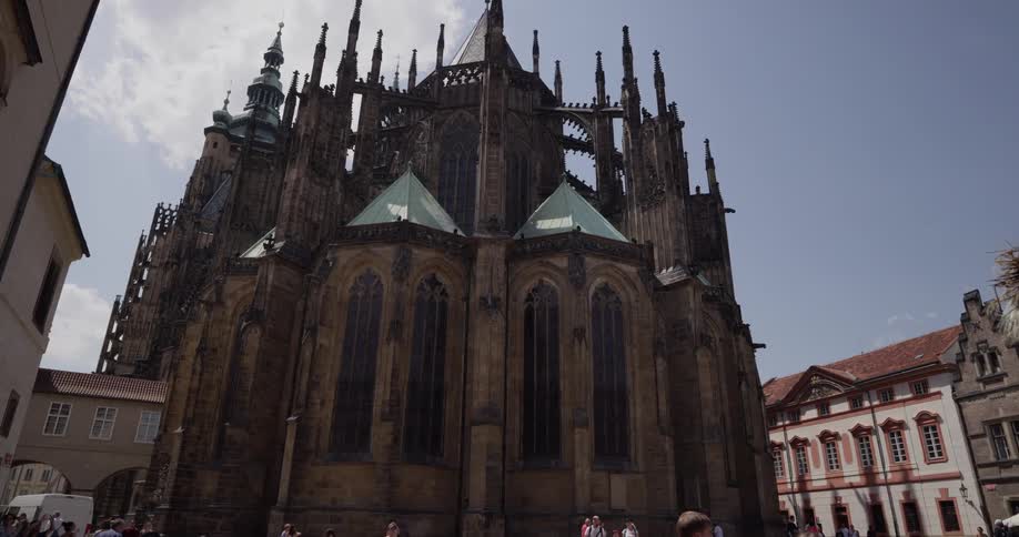 Tourists photograph and walk towards st vitus cathedral in prague