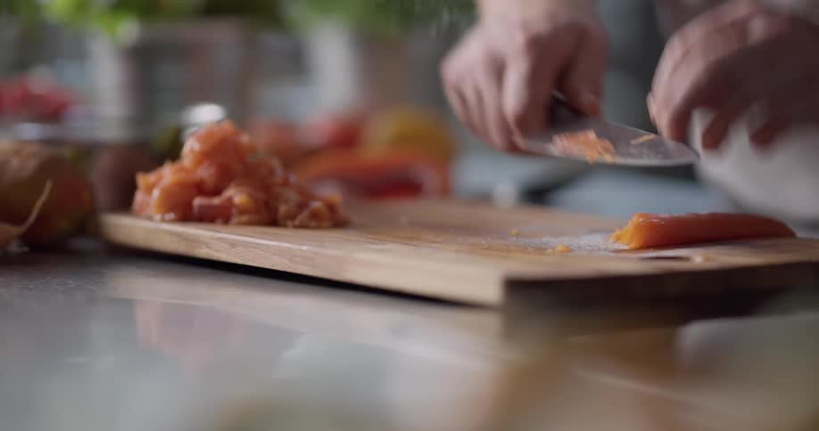Man chopping food in a kitchen