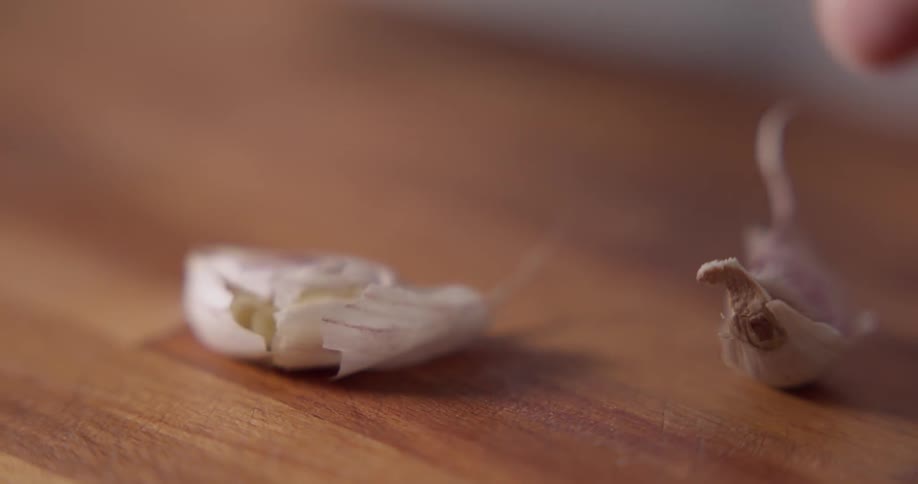 A close up shot of garlic being crushed