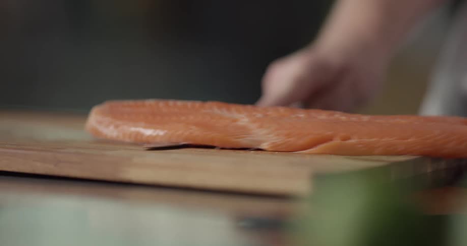 A chef skins a fish fillet