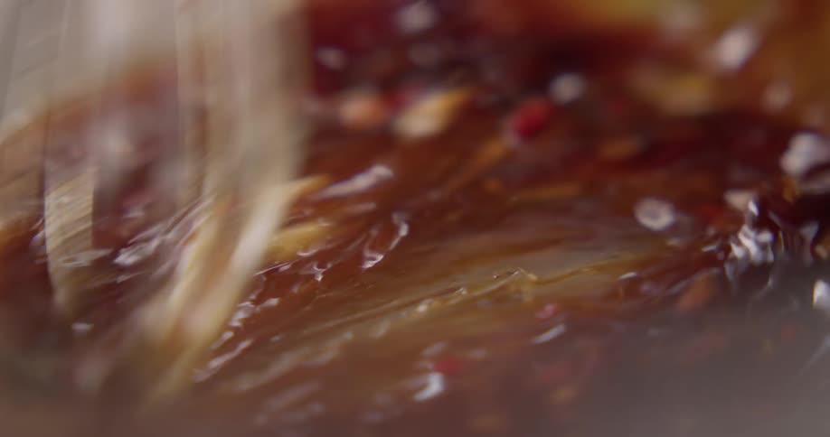 A person is whisking some sauce