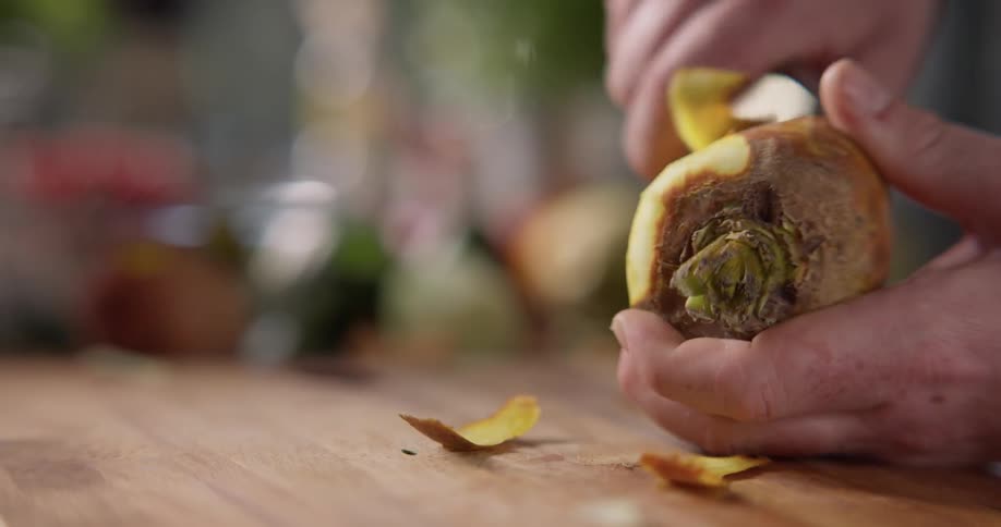 Chef peeling a carrot on a chopping board