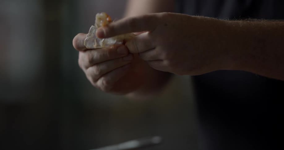 A chef peels the head and shells off shrimp