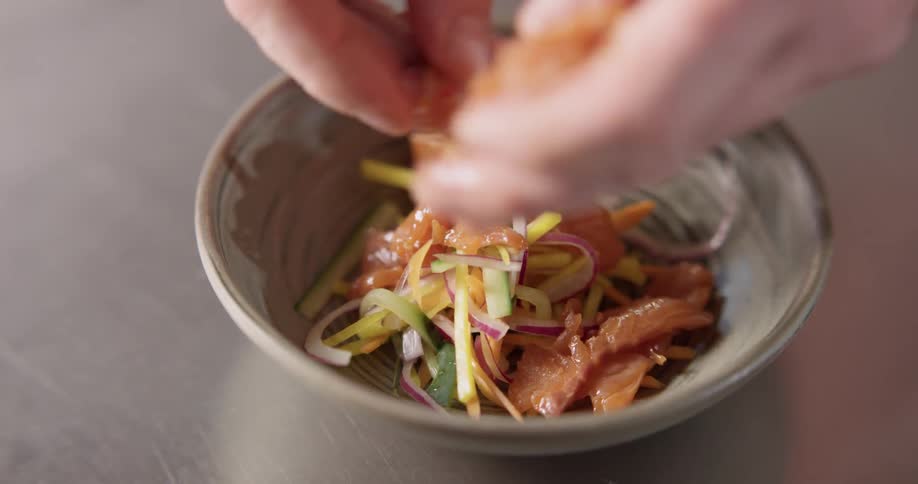 A cook assembling a small plate of food