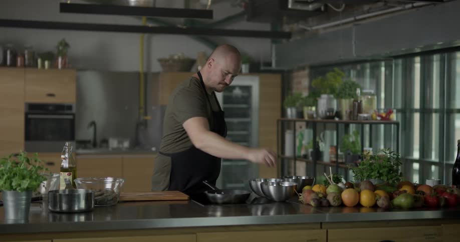 A man using a stovetop to cook