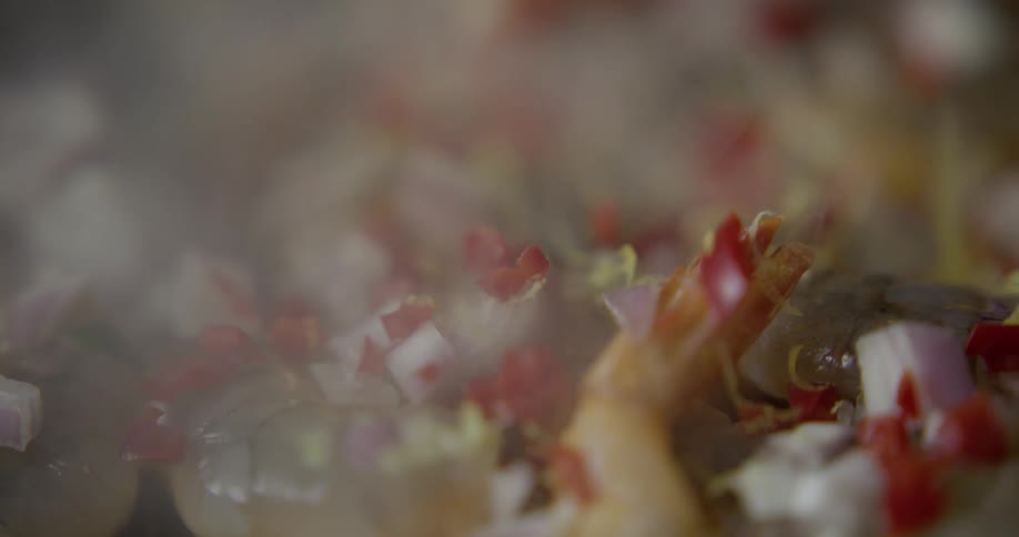 Seasoning is being dropped on top of food