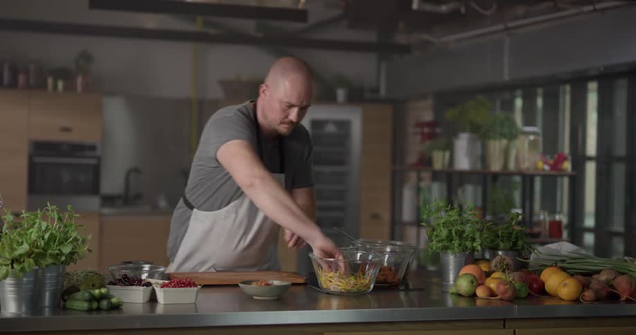Chef prepares dish at kitchen table