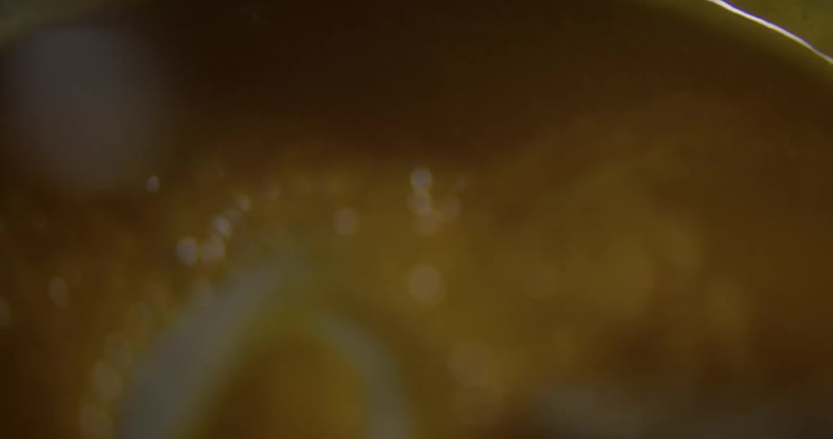 A person is mixing butter into sauce