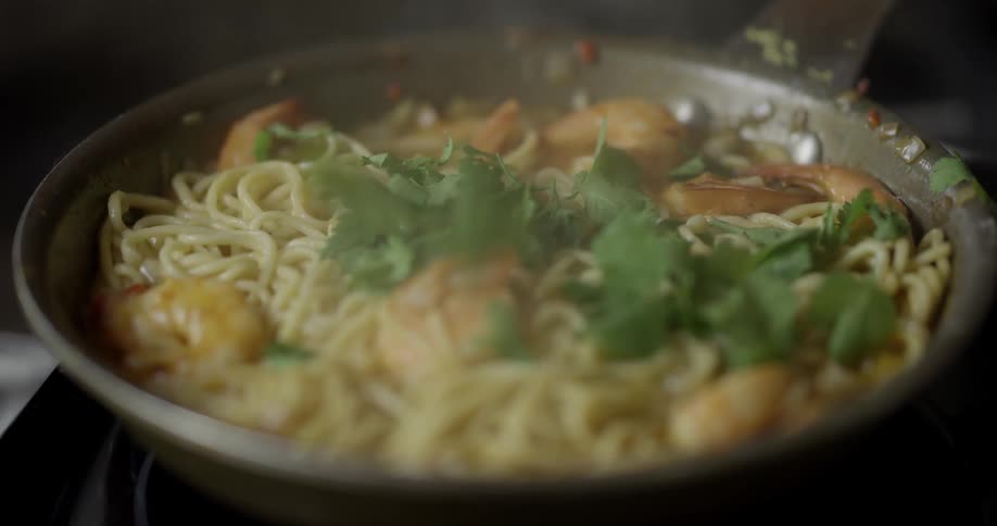 Herbs being sprinkled on top of a skillet meal