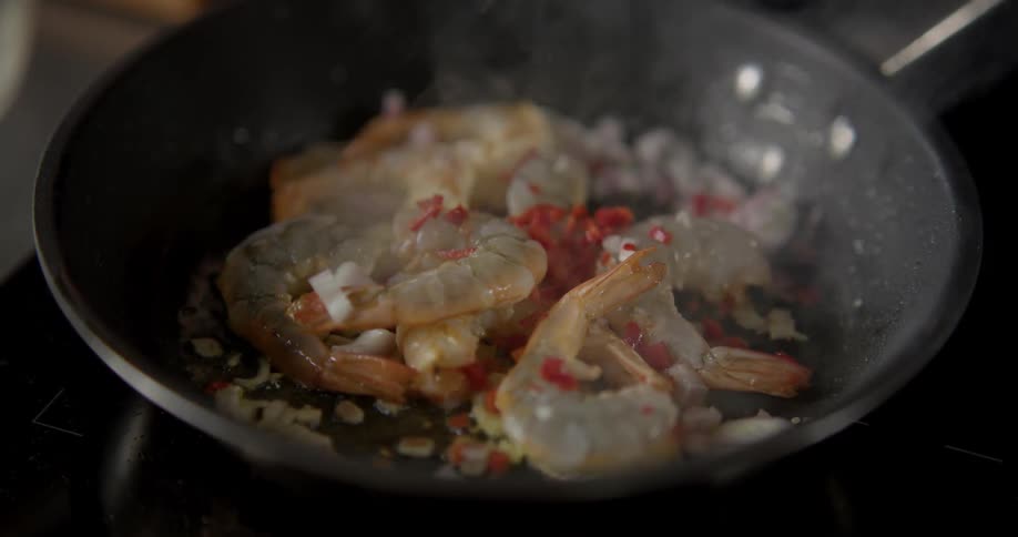 The seafood is cooking in the pan