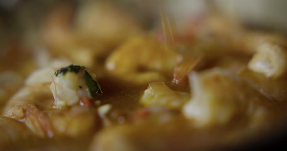 A sauce being poured on food