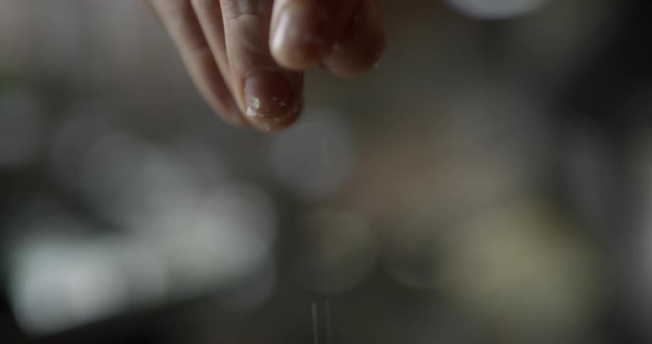 Man throws a pinch of salt into food