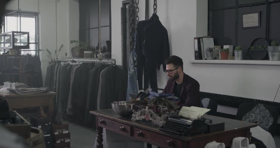 A man sitting at a table in a clothing shop