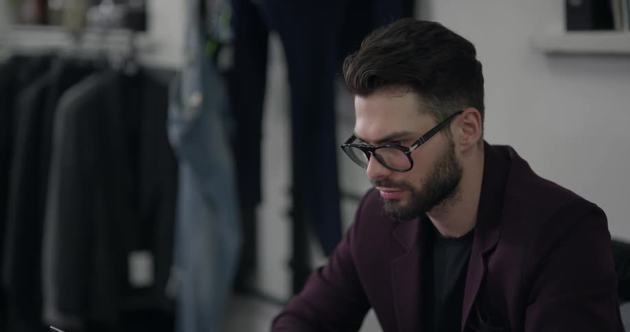 A man is typing on a laptop indoors