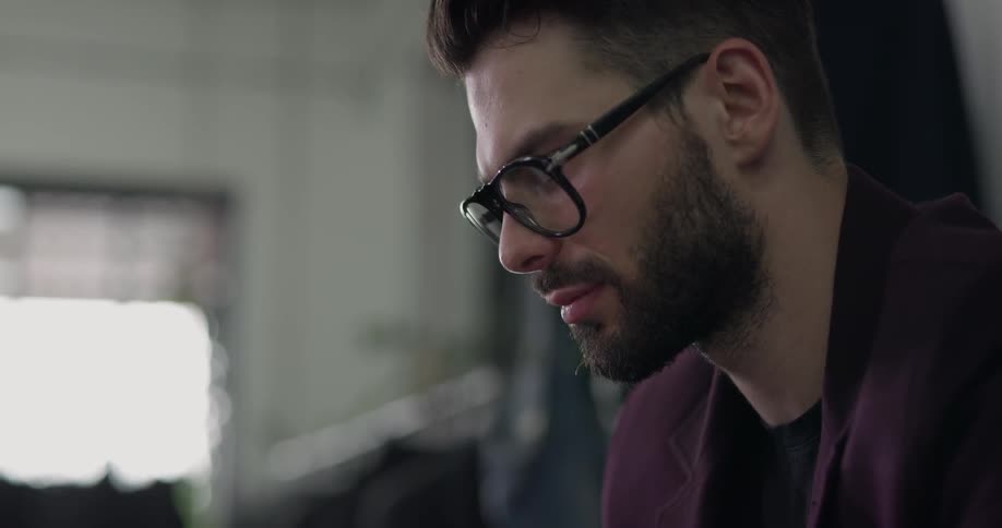 A man is looking at something indoors
