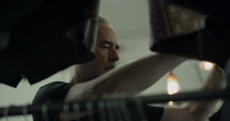 A man looks through a rack of clothes