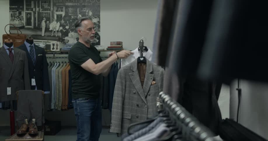 A man looks at clothes in a store