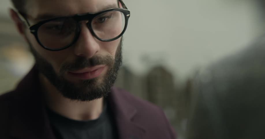 A tailor using pins to fit a suit