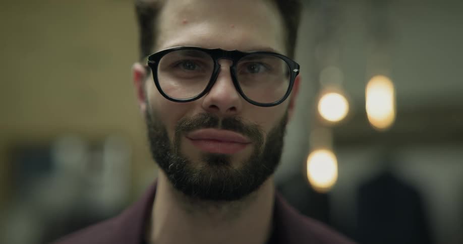 A man in a clothing store with glasses
