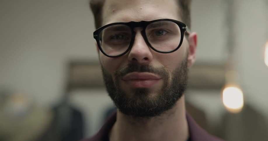 A man in a clothing store with glasses