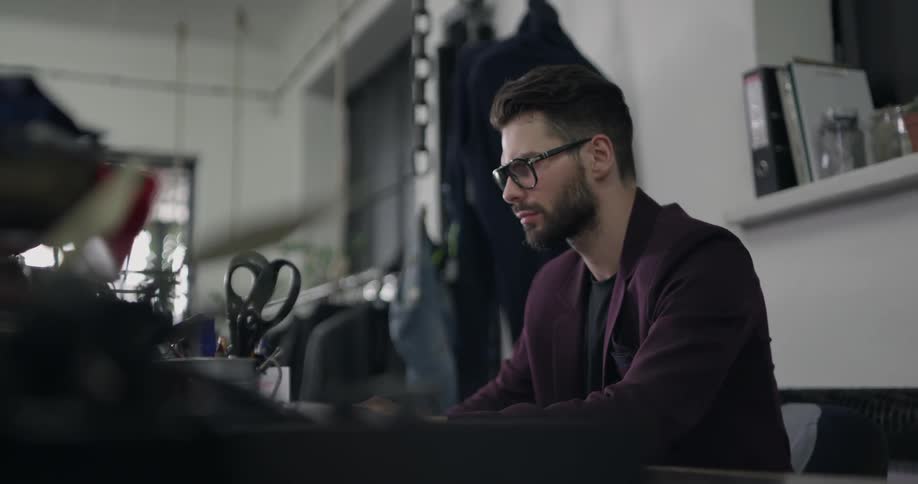 A man is sitting down in an office working