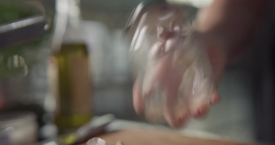 Person shakes garlic in jar