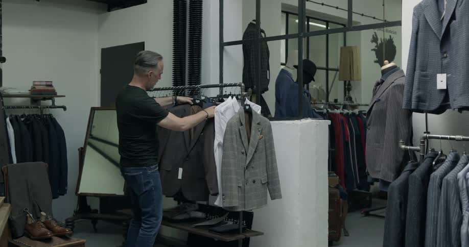 A man is shopping for clothes in a store