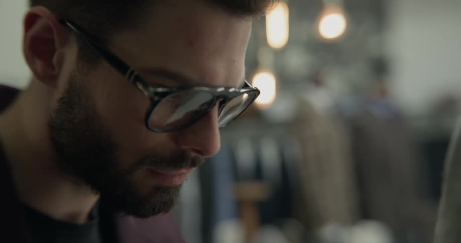 A tailor using pins to fit a suit