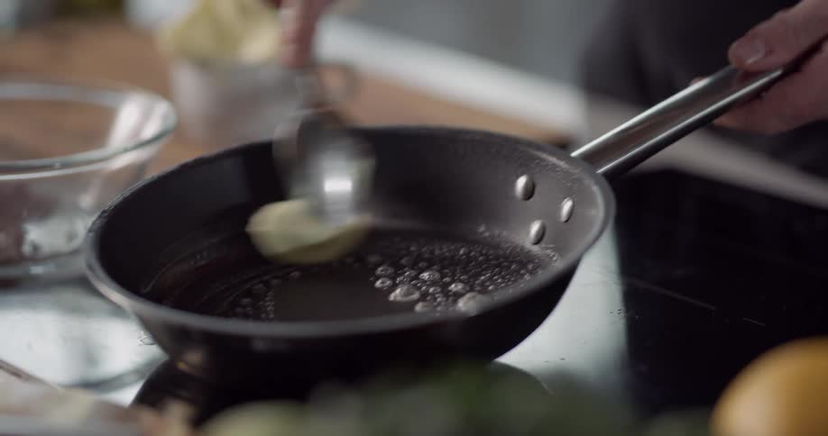 Chef adds butter to skillet