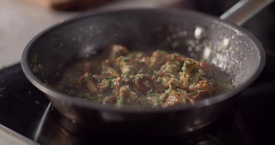 A mixture of food being cooked in a skillet
