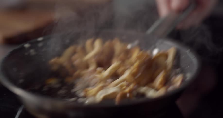 Cauliflower being fried stirred and tossed in a skillet