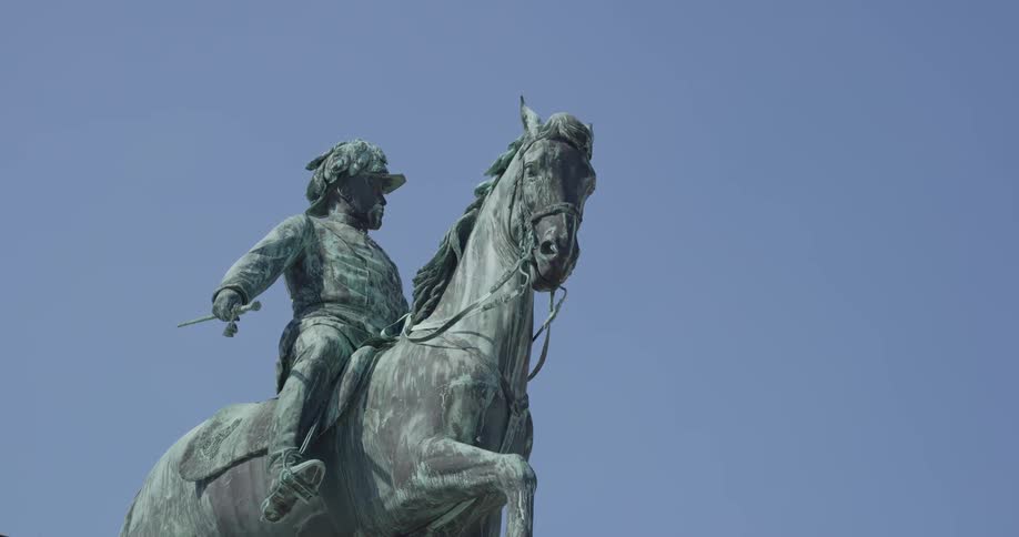 A statue of a man on a horse under a clear blue sky