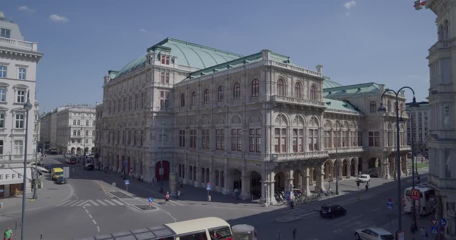 A city street with people walking and cars driving