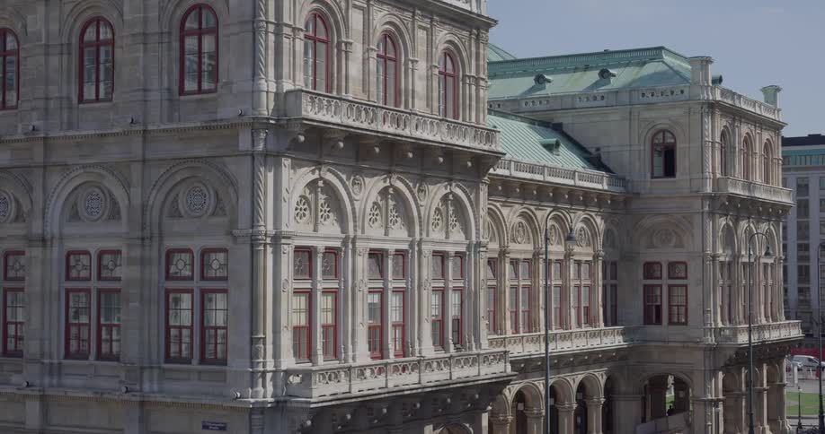 A beautiful old building with arches and columns and a copper roof