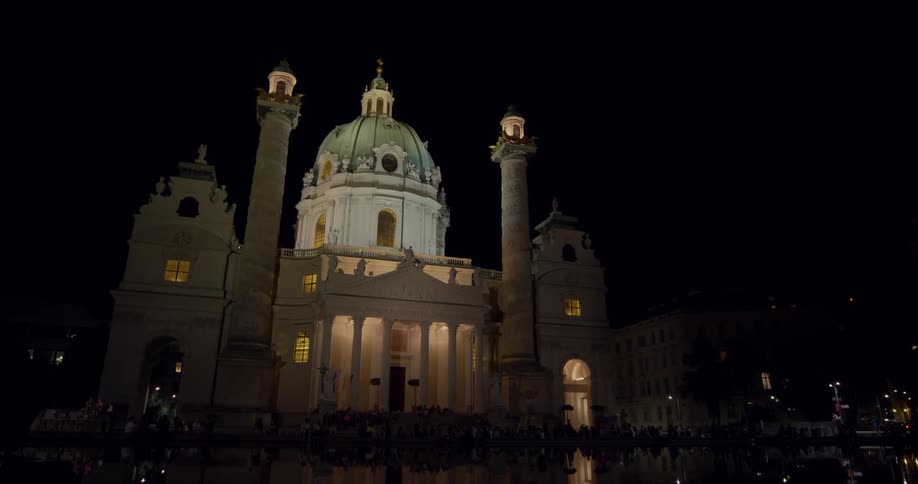 A large palace is lit up in the dark of night