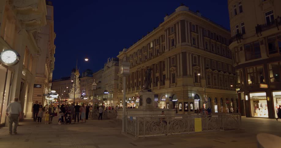 People walking city sidewalks at night