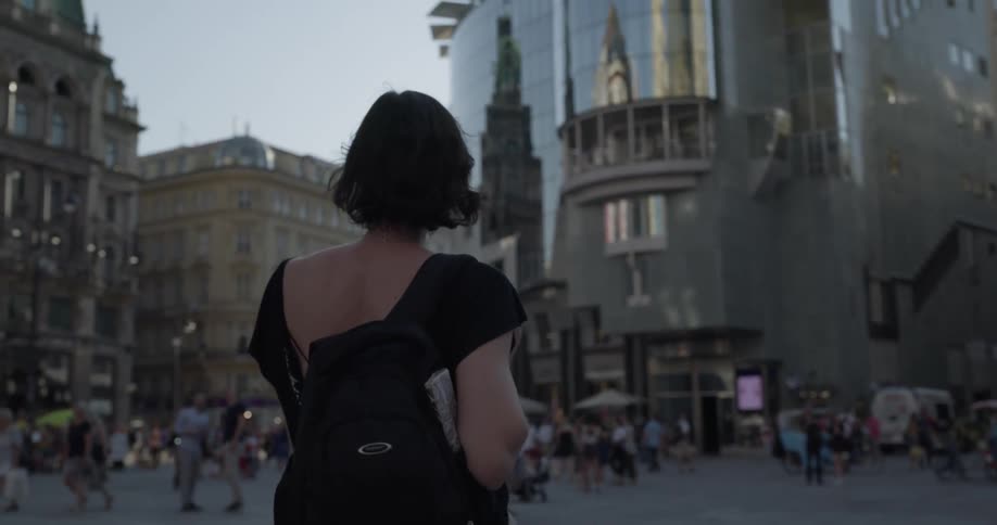 Woman walks around a plaza touring the city