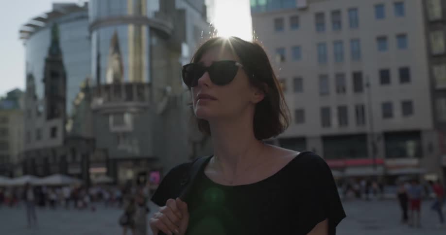 A woman is walking around looking over the city